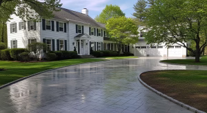 Driveway pressure washing guide showing a clean, freshly washed driveway leading up to a beautiful home with a well-maintained lawn and trees.